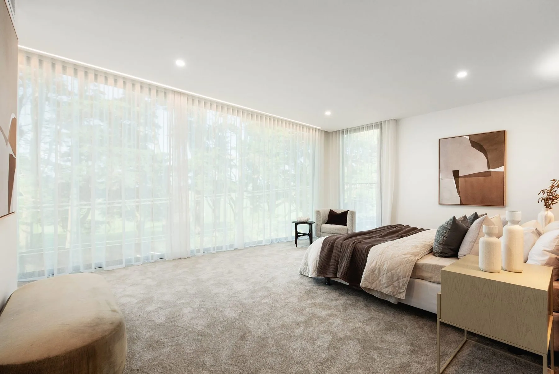 Main bedroom with a wall of sheer curtains