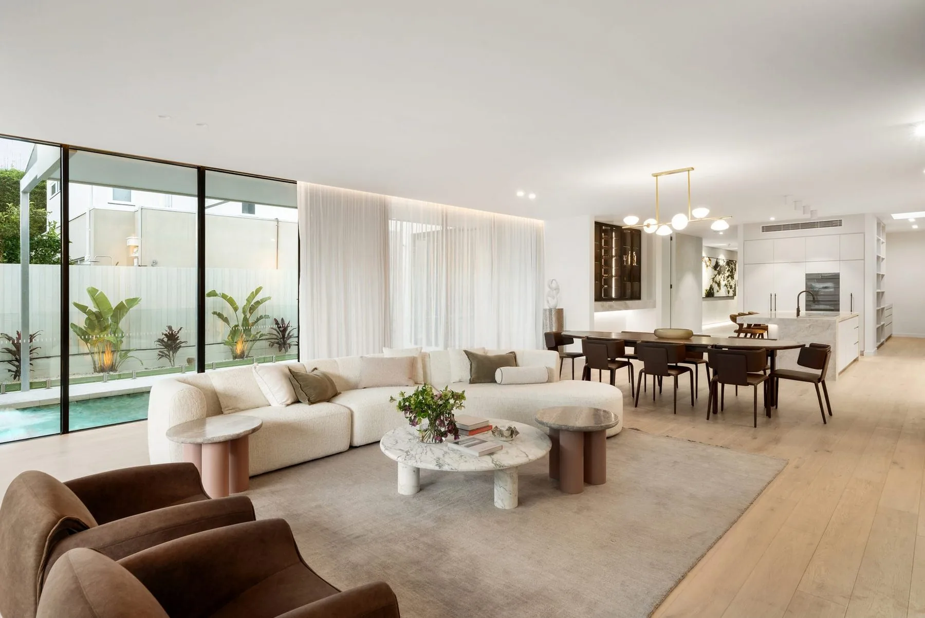 Open-plan living room with floor to ceiling sheer curtains